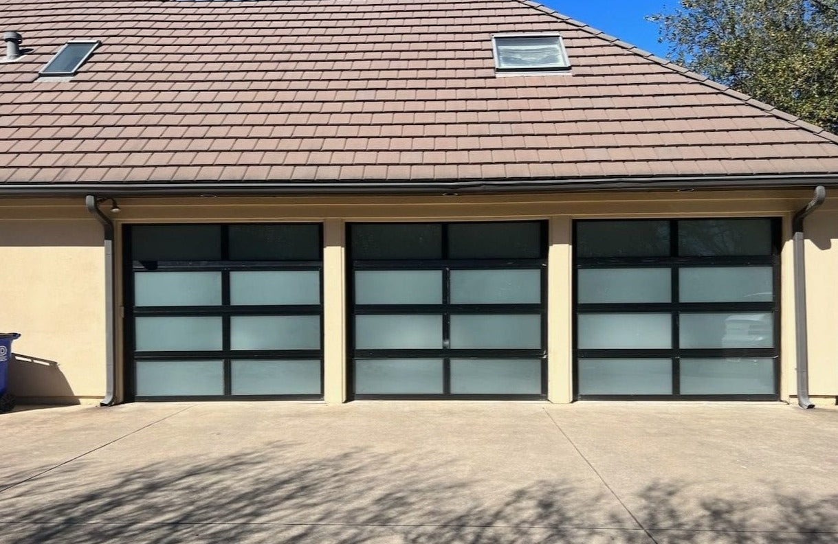 Frosted glass garage doors with a sleek, modern design on a contemporary home